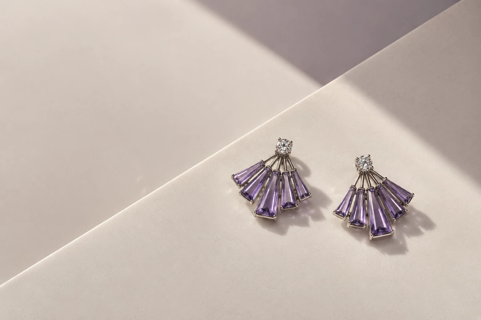 Concept violet baguette fan earrings in architectural light on pale ceramic